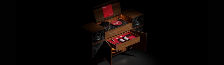 Grange record player console against black background.  A red record sits on top, two drawers are open to reveal two Grange magnums