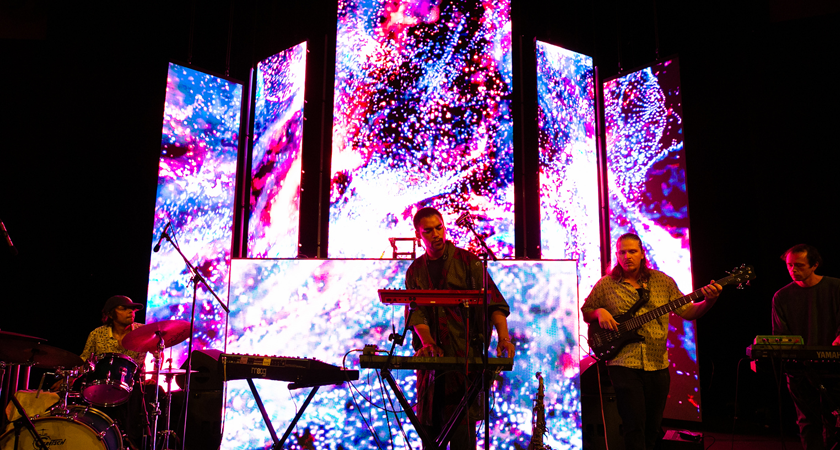 Musicians play against LED digital screens