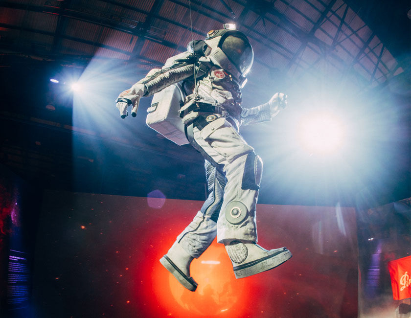 Astronaut mid air at event