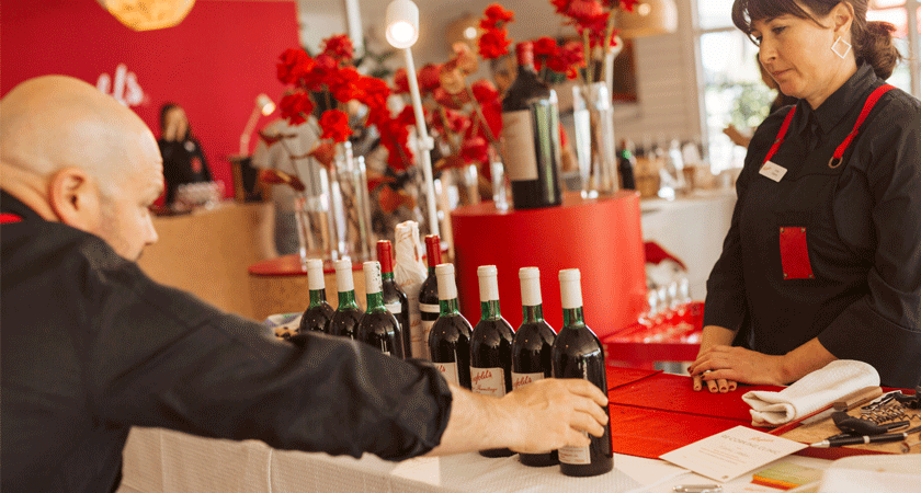 Winemaker, Matt Woo assesses the ullage height of a line up of Grange bottles