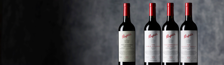 Four Penfolds Tribute range bottles against a grey background