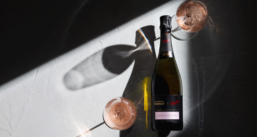 Champagne rose bottle with two filled glasses. Shot from overhead with the glasses casting shadows