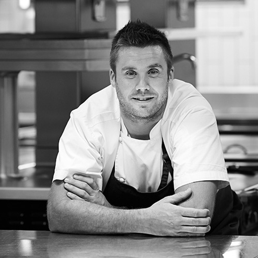 Scott Huggins, Head Chef, leans on kitchen bench