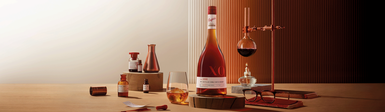 Penfolds brandy bottle amongst beakers and a bunse burner