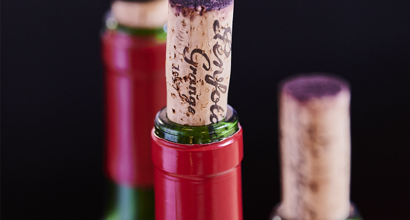 Three Penfolds Grange bottles.  Very close up with the cork removed and sitting in the top of the bottles