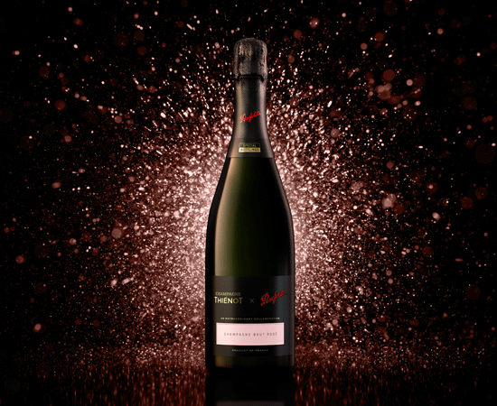 Black Penfolds champagne against pink sparkle background