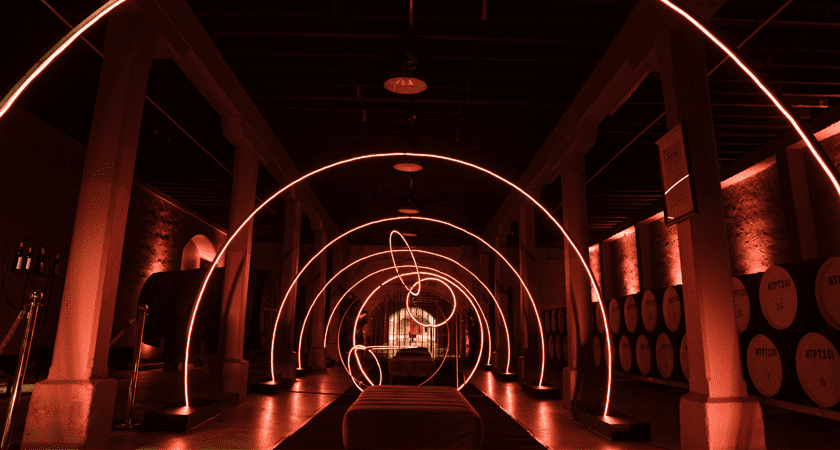 Red lit tunnels of Magill Estate.  Neon arches line the path