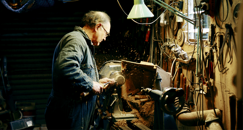 Cork closure being hand sawn 