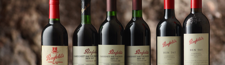 Line up of 7 Bin 707 Cabernet bottles of varying ages