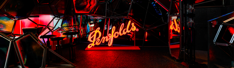 Entrance to event space.  Penfolds neon red cut out against mirrored surfaces