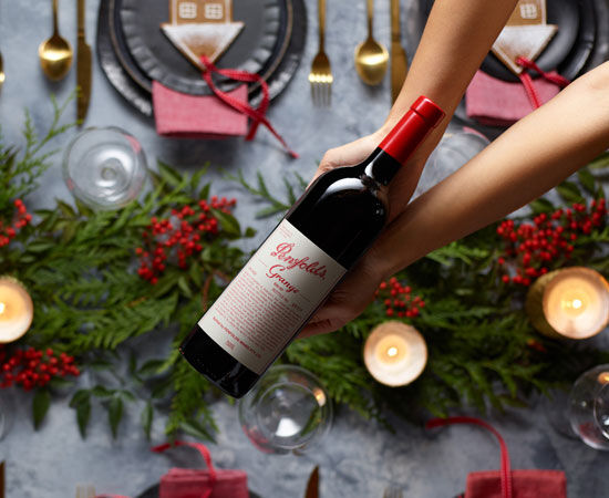 Bottle of Penfolds Grange being gifted over table scape