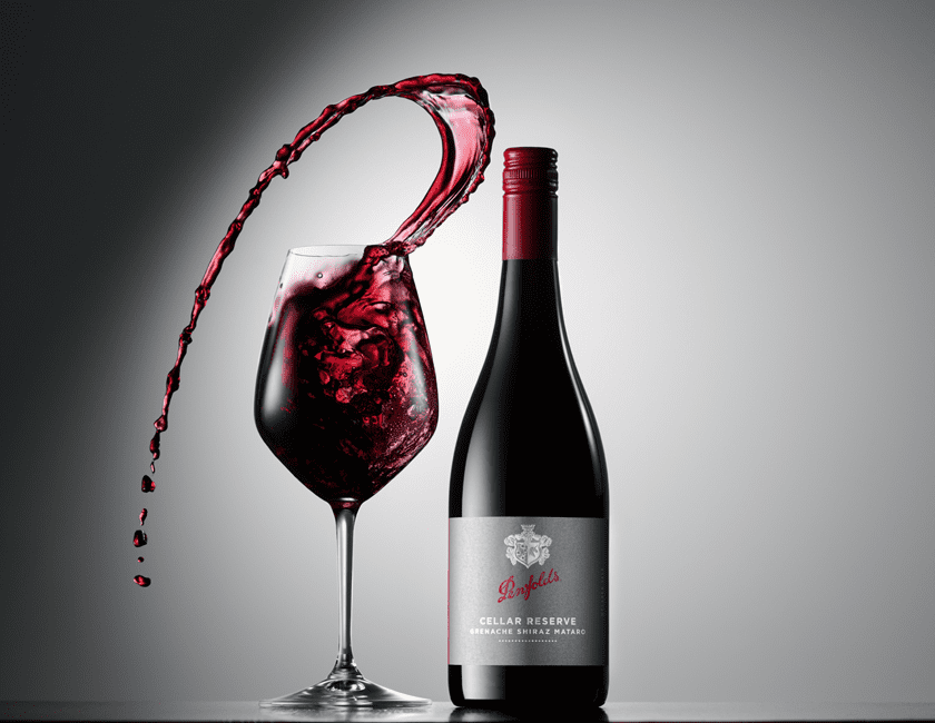 Cellar Reserve Grenache Shiraz Matato with wine glass. Wine dramatically leaps from the glass