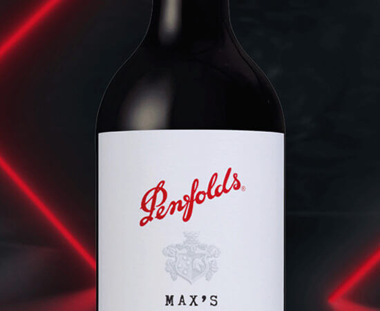 Close up of Max's bottle label against dark background with red neon beams
