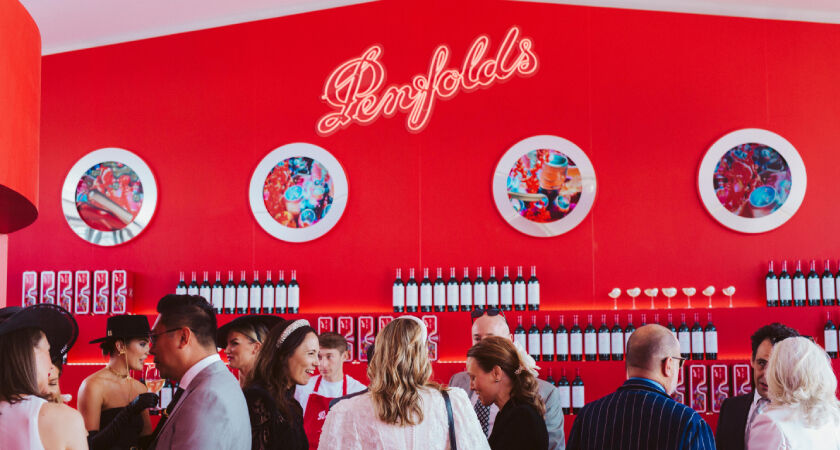The red bar of the Penfolds Marquee with people mingling in front