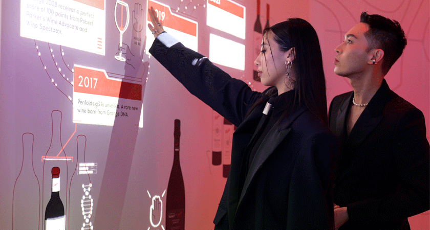 Guests play with interactive timeline screen at event