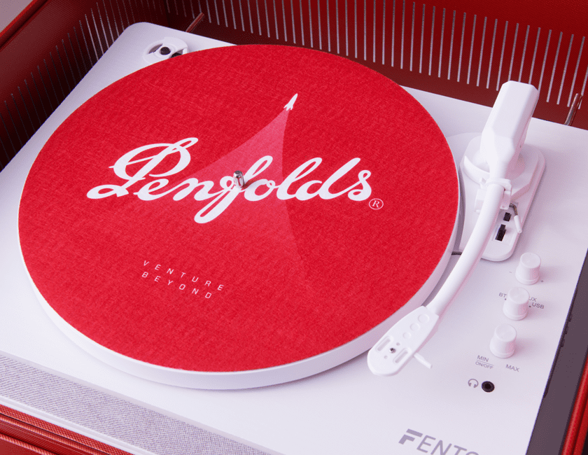 Penfolds red record sits on a white record player turntable 