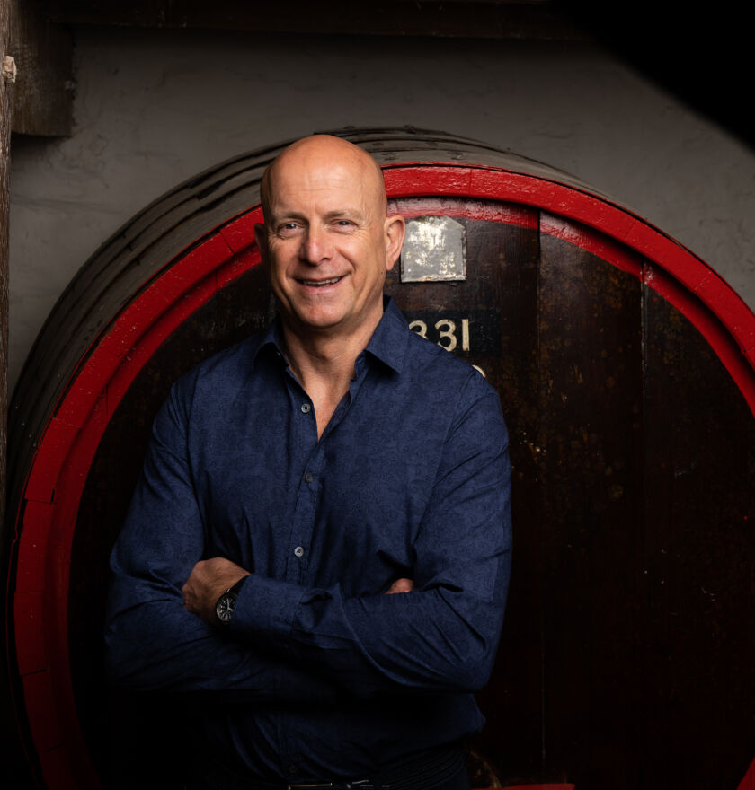 Andrew Hales, Penfolds Winemaker, in front of Penfolds barrel.