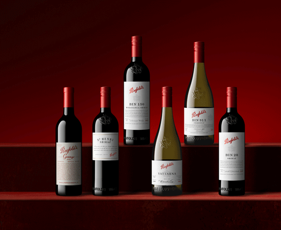 6 Penfolds bottles against a dark red background