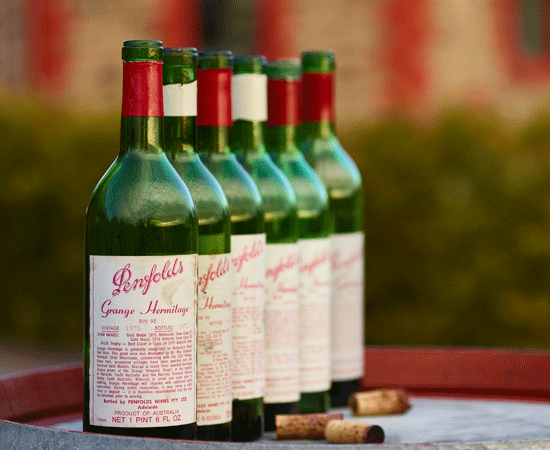 5 heritage Grange wine bottles on a barrel 