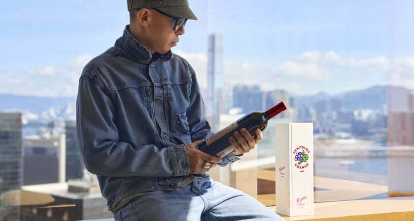 NIGO holding a bottle of limited edition Penfolds Grange with Tokyo backdrop