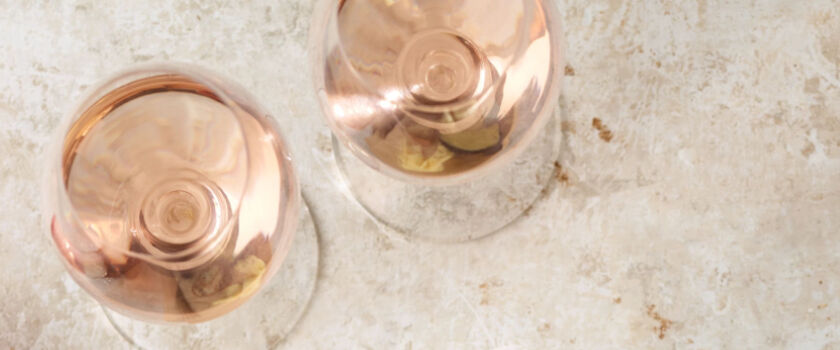Two glasses of rose photographed from a birds-eye view. 
