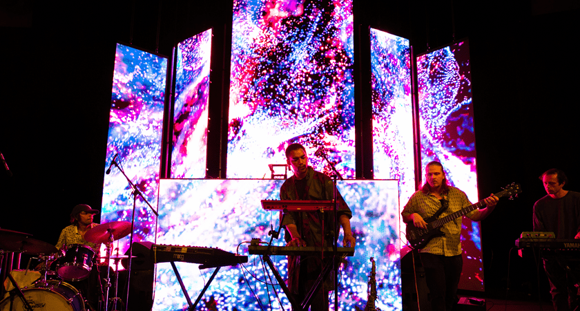 Musicians play against LED digital screens