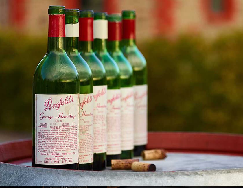 Heritage Bottles of Penfolds Grange Aligned on Wine Barrel