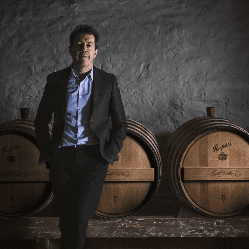Peter Gago, Penfolds Chief Winemaker, stands in front of Magill Cellar 3 barrels